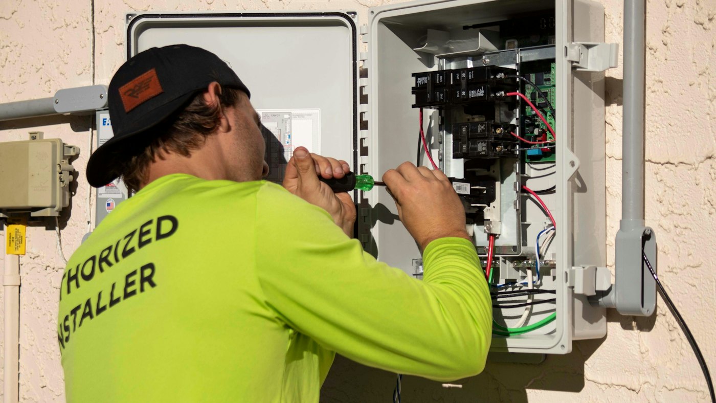 Technician testing an outdoor electrical panel