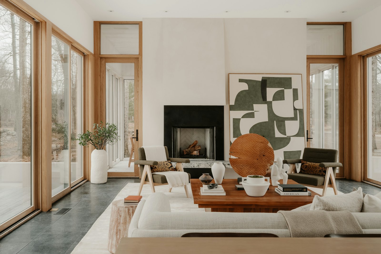 Warm modern living room with a fireplace and large windows